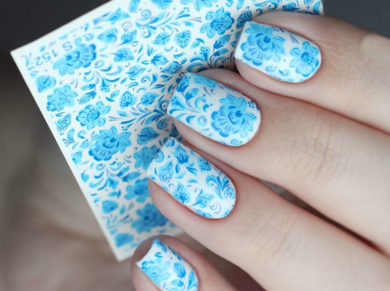 Дизайн ногтей с голубыми слайдами на белом фоне
